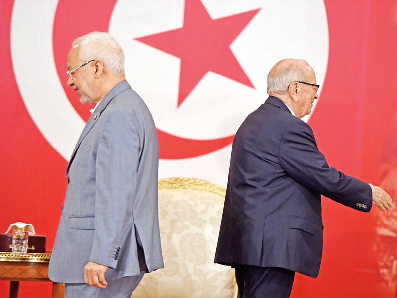 السبسي وزعيم «النهضة» في صورة أرشيفية    (أ ف ب)