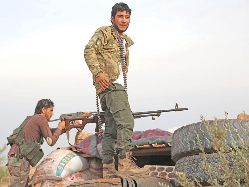 مقاتلان بجبهة التحرير على خط المواجهة مع قوات النظام في إدلب أمس (أ ف ب)