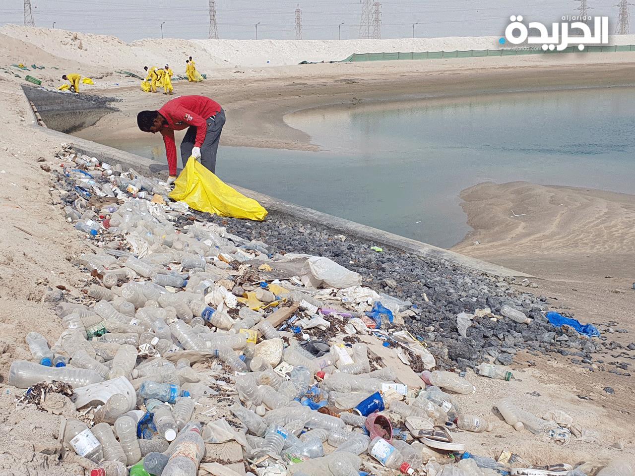  أعضاء فريق الغوص الكويتي أثناء رفع المخلفات من سواحل الخيران 