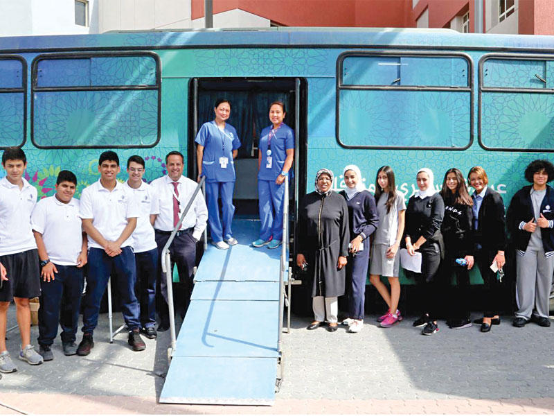 الطلاب والطالبات مع العيادة المتنقلة 