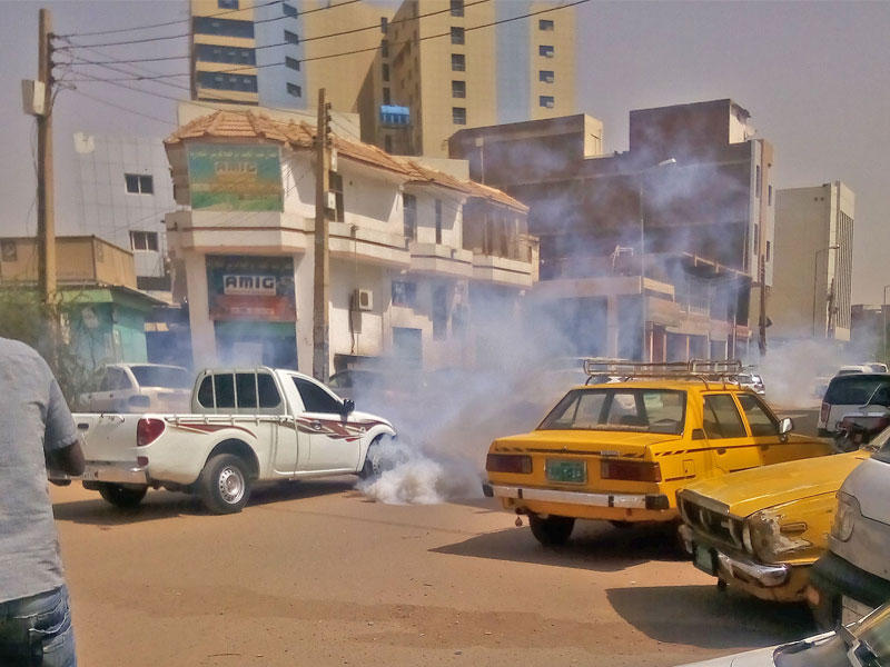 الغاز المسيل للدموع وسط السيارات بعد أن استخدمته قوات الأمن السودانية لتفريق المتظاهرين