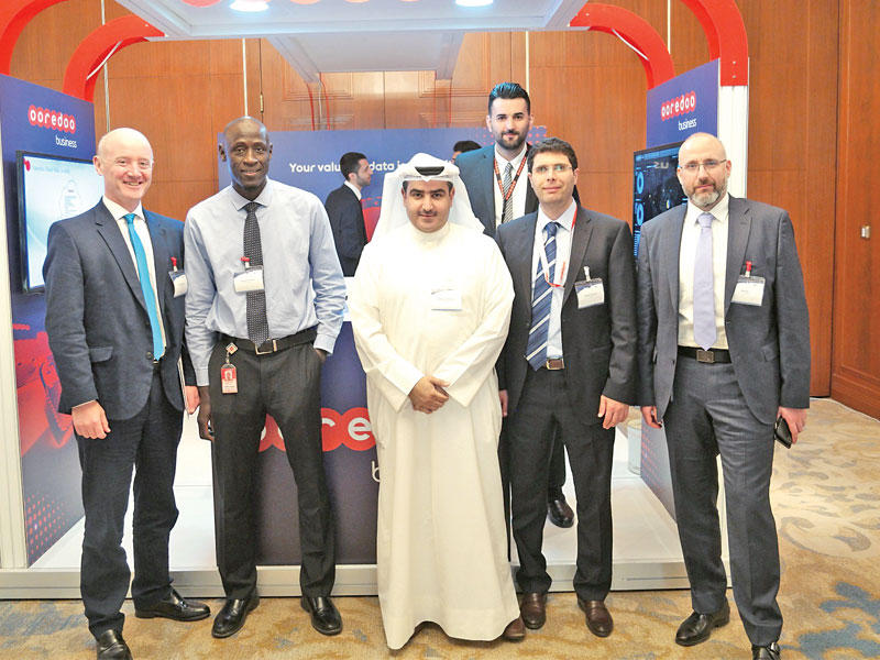 عبدالعزيز البابطين متوسطاً فريق العمل أمام جناح Ooredoo