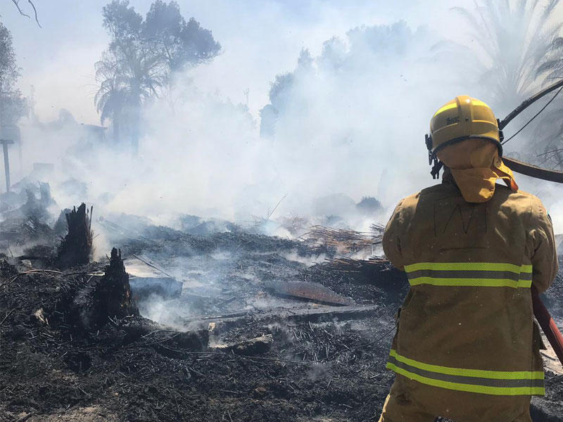 أحد رجال الإطفاء يكافح الحريق