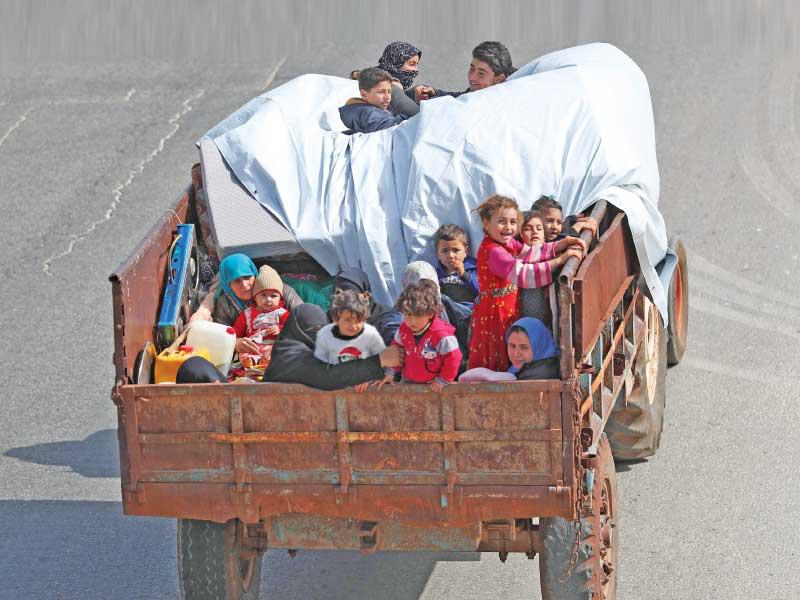 عائلات سورية تنزح عن المناطق المستهدفة بإدلب أمس (أ ف ب)