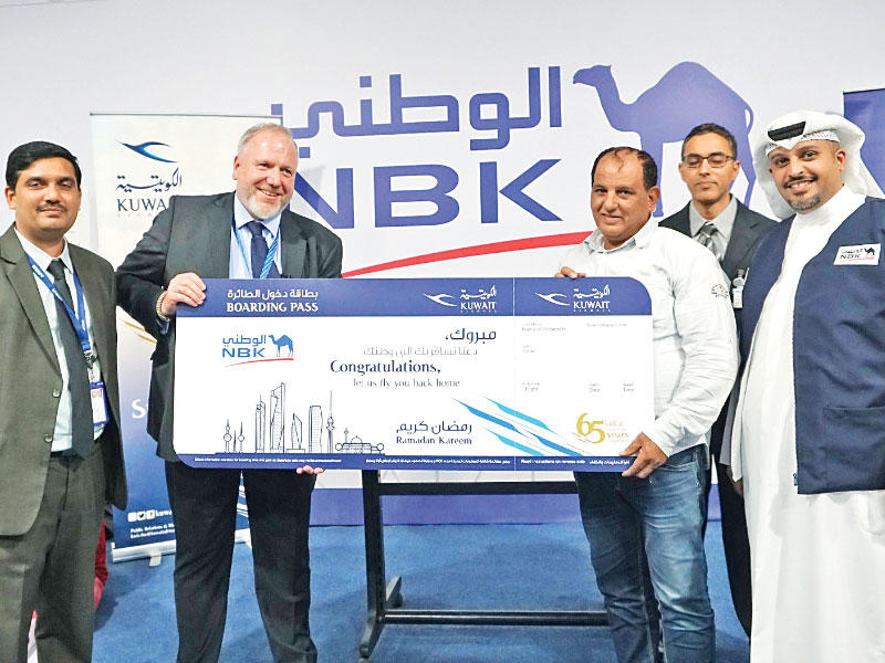 أحد الفائزين يتسلم التذكرة