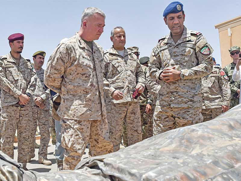 المتحدث باسم «تحالف دعم الشرعية» تركي المالكي يعرض لقائد القيادة المركزية الأميركية وقائد قوات التحالف فهد بن تركي أسلحة صادرتها القوات السعودية من المتمردين الحوثيين داخل قاعدة عسكرية في الخرج قرب الرياض أمس (أ ف ب)