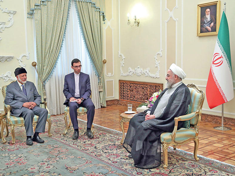 روحاني مستقبلاً بن علوي في طهران أمس (أ ف ب)