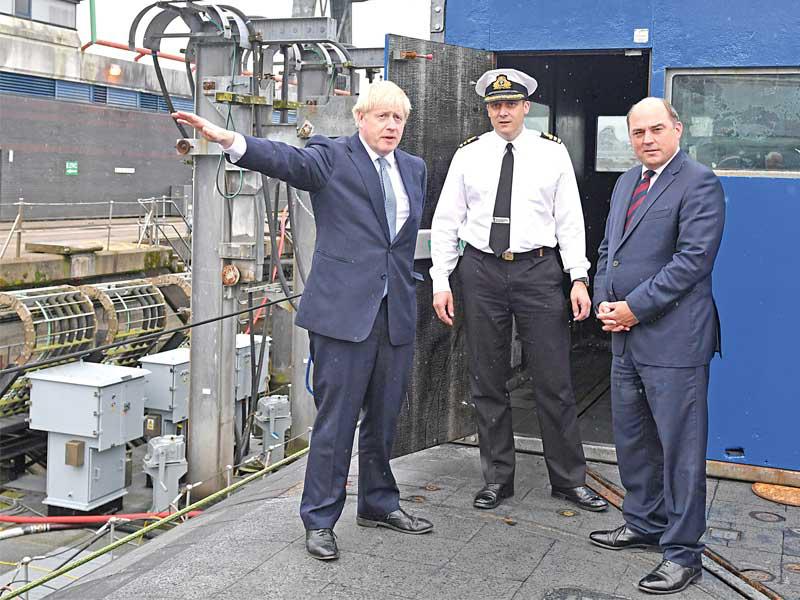 جونسون ووزير دفاعه بن والاس يزوران قاعدة بحرية في اسكتلندا أمس       (رويترز)