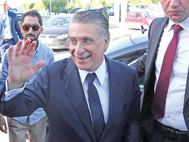 القروي لدى وصوله إلى مكتبه بعد خروجه من السجن أمس (اي بي آيه)