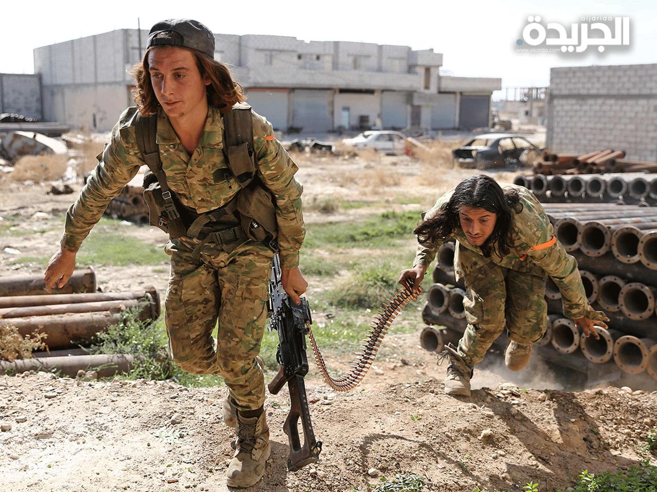 nعناصر من الجيش الوطني السوري التابع لتركيا خلال مواجهاته مع المقاتلين الأكراد
