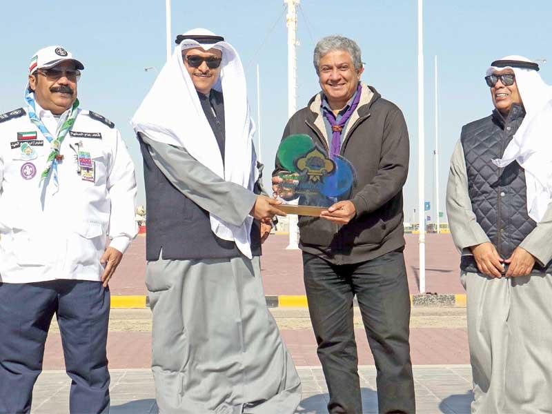 وكيل وزارة التربية بالإنابة، م. ياسين الياسين والوكيل المساعد للتنمية التربوية والأنشطة فيصل المقصيد يكرمان أحد المشاركين في المخيم الكشفي