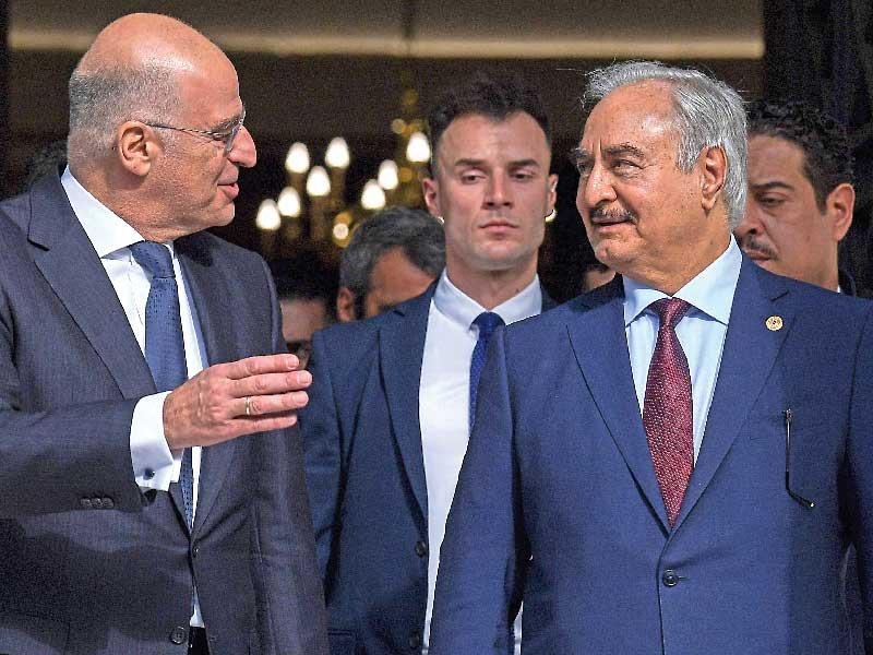 وزير خارجية اليونان نيكوس ديندياس متحدثاً إلى حفتر في أثينا أمس الأول     (أ ف ب)