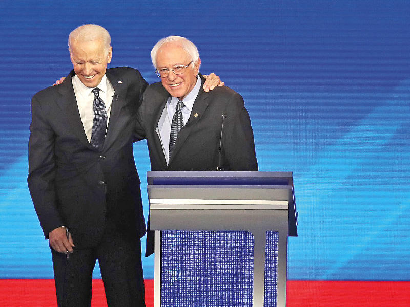 معانقة بعد سجال خلال مناظرة المرشحين الديمقراطيين أمس الأول  (أ ف ب)