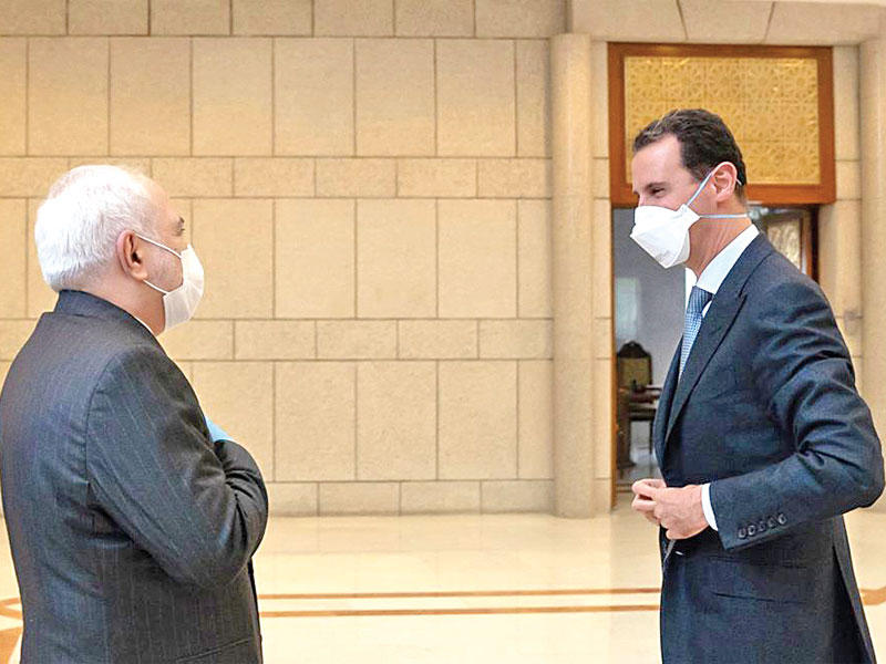 الأسد مستقبلاً ظريف دون مصافحة في دمشق أمس (الرئاسة السورية)