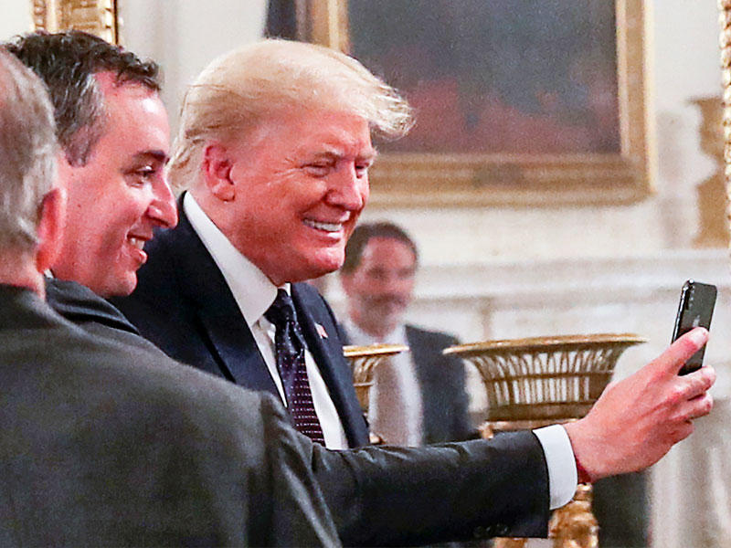 مدير أحد المطاعم يلتقط «سيلفي» مع دونالد ترامب خلال لقاء في البيت الأبيض أمس الأولt (رويترز)