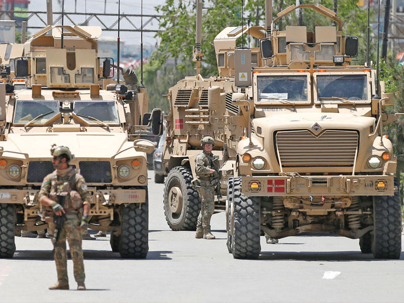 جندي يراقب وسط عربات مدرعة خارج مستشفى تعرضت لهجوم في كابول - أفغانستان 