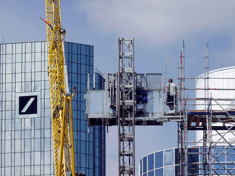 عامل بناء يدير مصعدًا في موقع بناء في فرانكفورت ، ألمانيا 