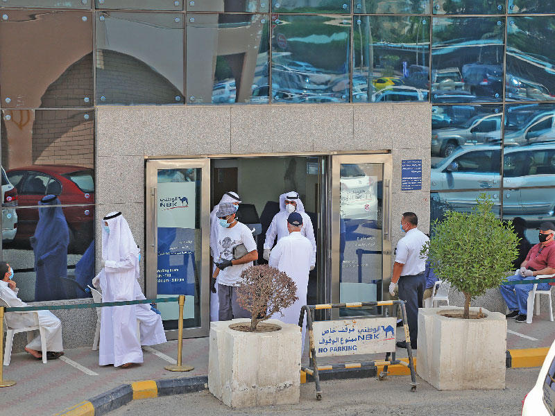 جانب من عمليات تنظيم دخول بنك الكويت الوطني في يومه الاول للعمل