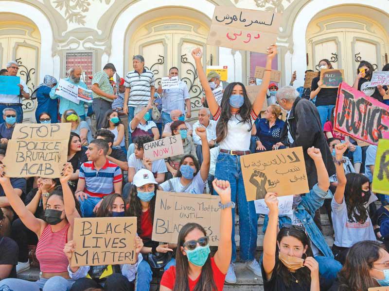 في الصورة تونسيون خلال وقفة تضامنية في العاصمة التونسية أمس (أ ف ب)