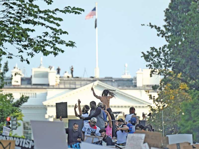 محتجون يلعبون على أنغام الموسيقى خلال تجمع أمام البيت الأبيض أمس الأول (رويترز)