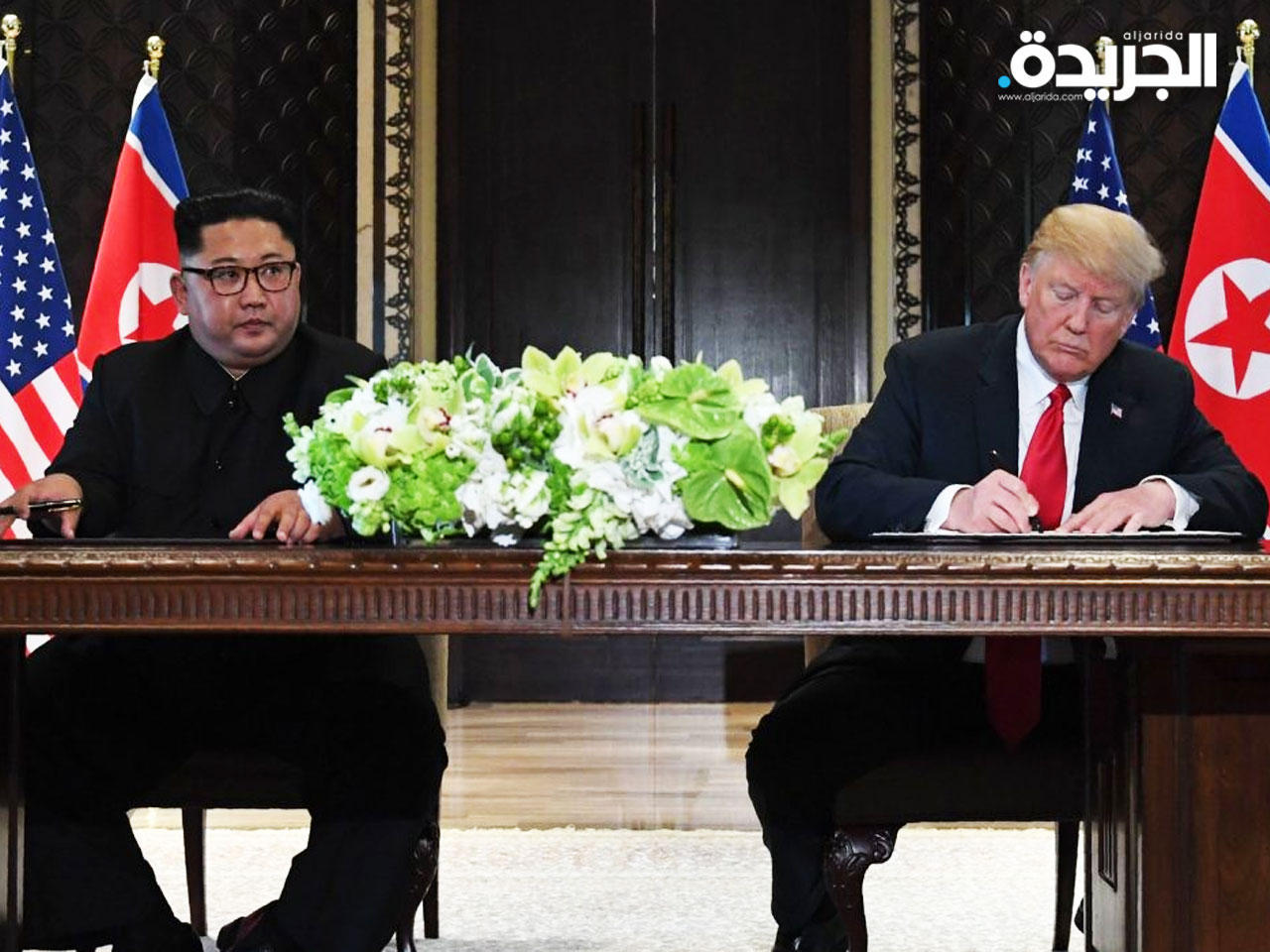 جانب من اللقاء التاريخي السابق بين الرئيسين ترامب كيم يونغn