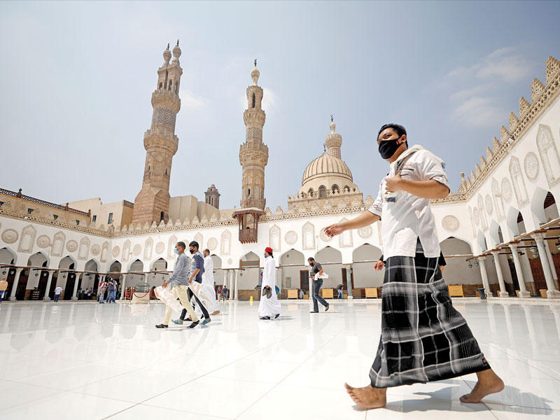 مصلون في باحة الأزهر أمس الأول يتجهون لأداء أول صلاة جمعة منذ 5 أشهرt (رويترز)