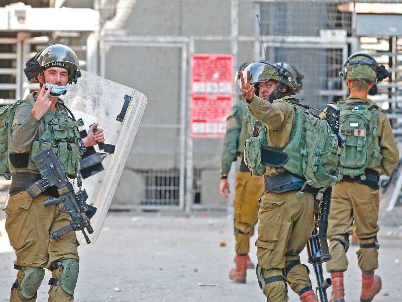 جنود إسرائيليون خلال مواجهات مع الفلسطينيين بالخليل في الضفة أمس الأول (ا ف ب)