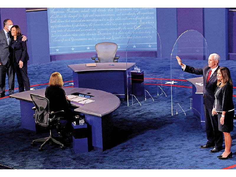  هاريس وزوجها دوغلاس إمهوف وبنس وعقيلته كارين بعد المناظرة في قاعة كينغسبري في جامعة يوتا أمس (رويترز)