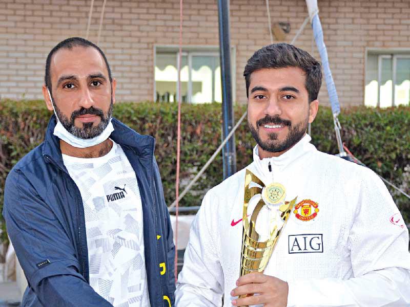 عبدالعزيز المخلد يتسلم الكأس من رئيس اللجنة أحمد الفيلكاوي