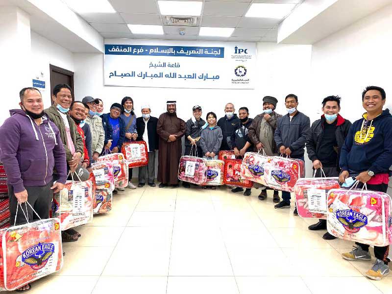 جانب من توزيع  لجنة التعريف بالإسلام كسوة الشتاء على عمال النظافة