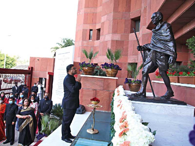السفير الهندي أمام ثمثال المهاتما غاندي على مدخل السفارة أمس