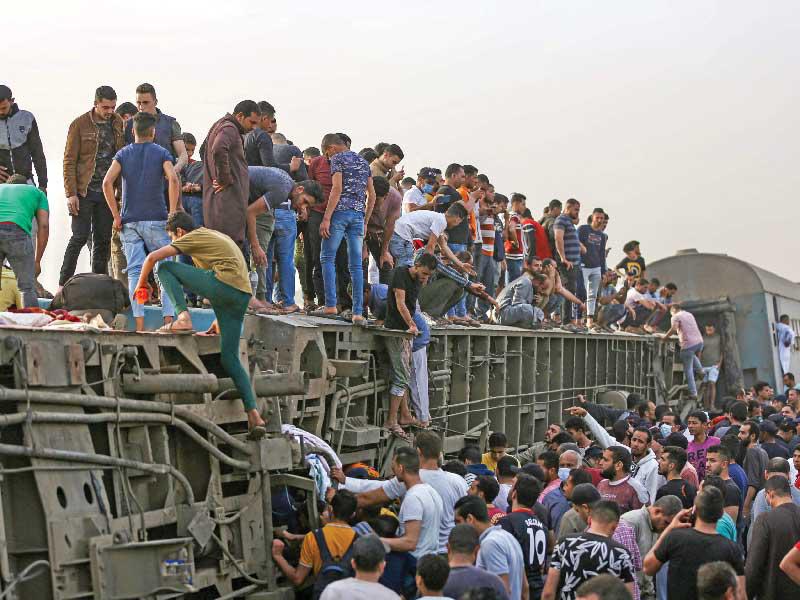 مصريون في موقع حادث قطار طوخ (أ ف ب)  