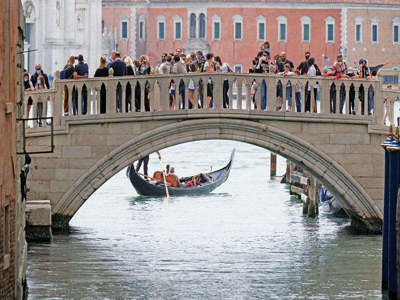 سيّاح في مدينة البندقية الإيطالية أمس (رويترز)