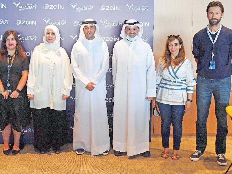 الرئيس التنفيذي لشركة زين الكويت إيمان الروضان والرئيس التنفيذي لشركة التمدين الرياضية محمد المرزوق يتوسطان مسؤولي زين والأكاديمية 