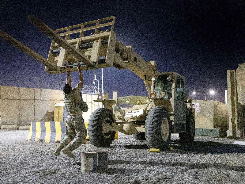 جندي أميركي يقوم بتمرينات مستعيناً بآلية عسكرية ببغداد    (أ ف ب)