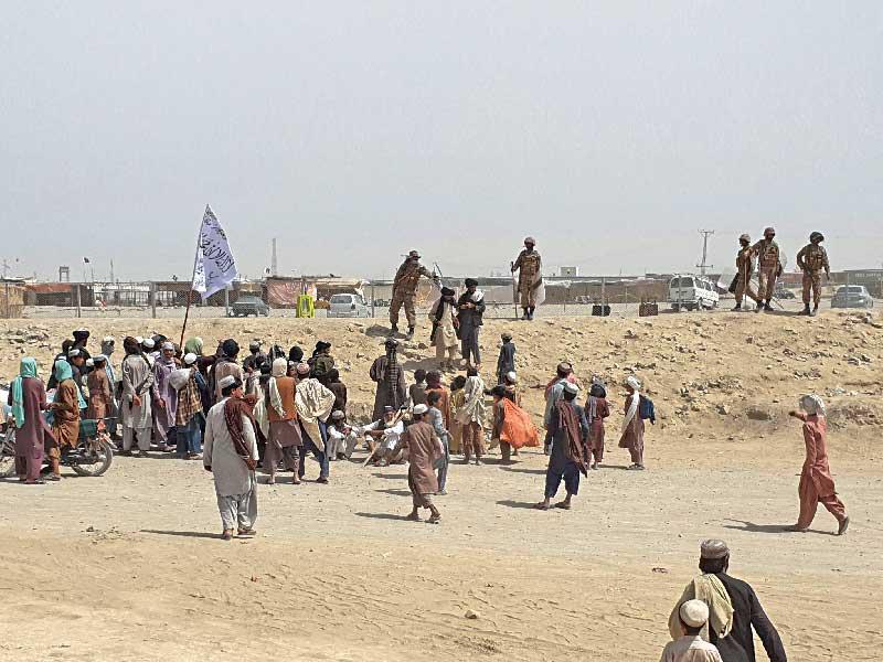 عناصر من حرس الحدود الباكستاني يمنعون أشخاصاً يحاولون العبور إلى الجانب الأفغاني أمس             (أ ف ب)