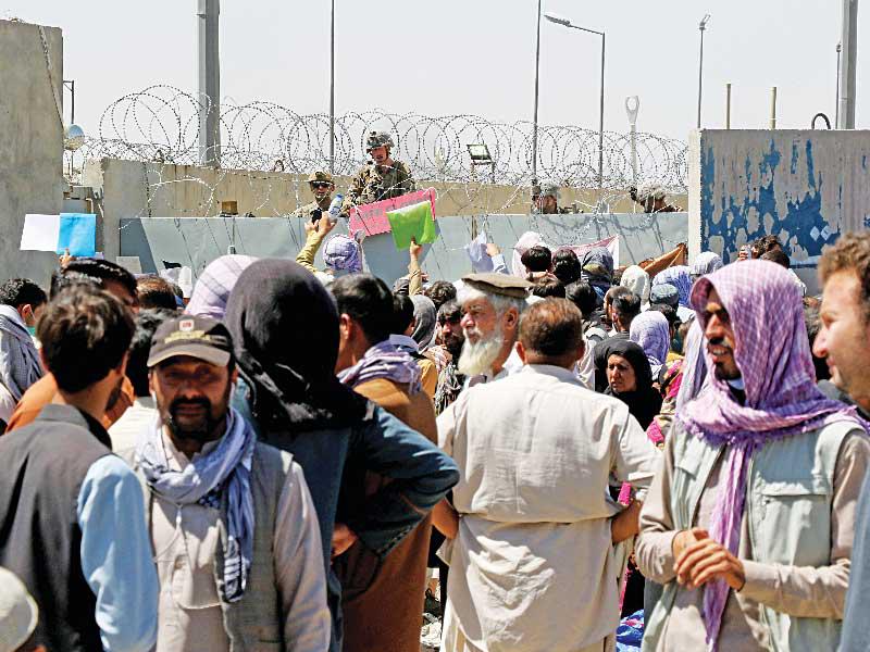 حشود من الافغان أمام أحد مداخل مطار كابول قبل وقوع الانفجارين أمس (رويترز)n