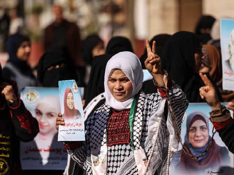 فلسطينيات خلال وقفة تضامن مع الأسيرات في السجون الإسرائيلية أمام مكتب «الصليب الأحمر» في غزة أمس (أ ف ب)