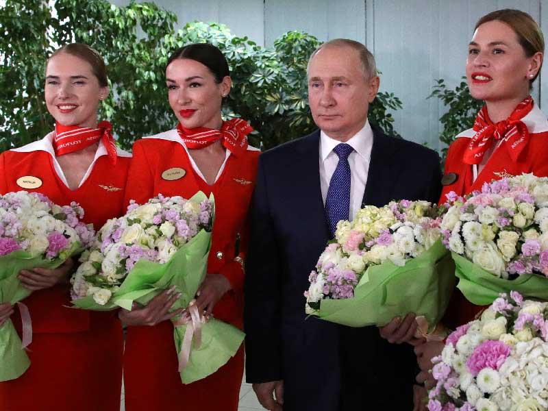 بوتين محاطاً بمجموعة من المضيفات في مركز تابع لشركة «إيروفلوت» اليوم (رويترز)