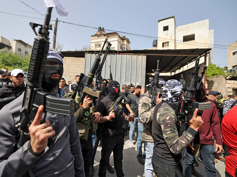 مسلحون يشاركون بتشييع زكارنة في جنين أمس (أ ف ب)