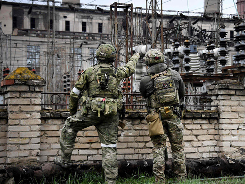  جنديان روسيان أمام محطة لتوليد الكهرباء في لوغانسك (أ ف ب)