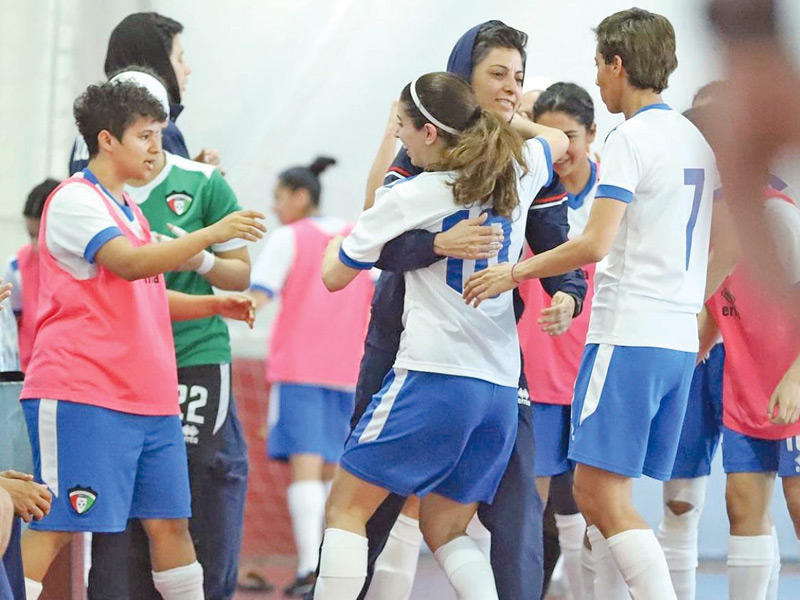 لاعبات منتخب الصالات يحتفلن بالفوز مع مدربة الفريق