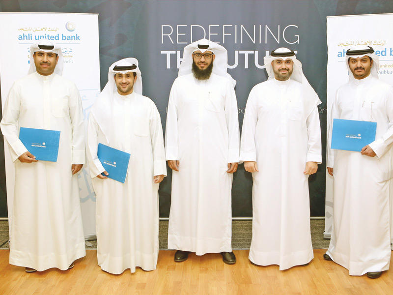 مساعد المدير العام للتدقيق الشرعي الداخلي عبدالله الشعيب والماجد من إدارة الرقابة الشرعية بـ «المتحد» يتوسطان المتدربين