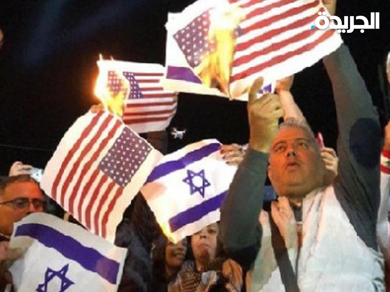 إحراق العلمين الأمريكي والإسرائيلي في مسيرة تضمانية مع فلسطين
