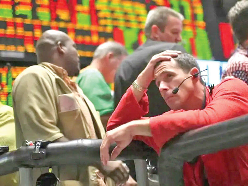 صورة ارشيفية لمؤشرات البورصة التي شهدت هبوط حاد في مؤشراتها ويبدو احد المتداولين متحساراً على هبوط قيمة اسهمه 