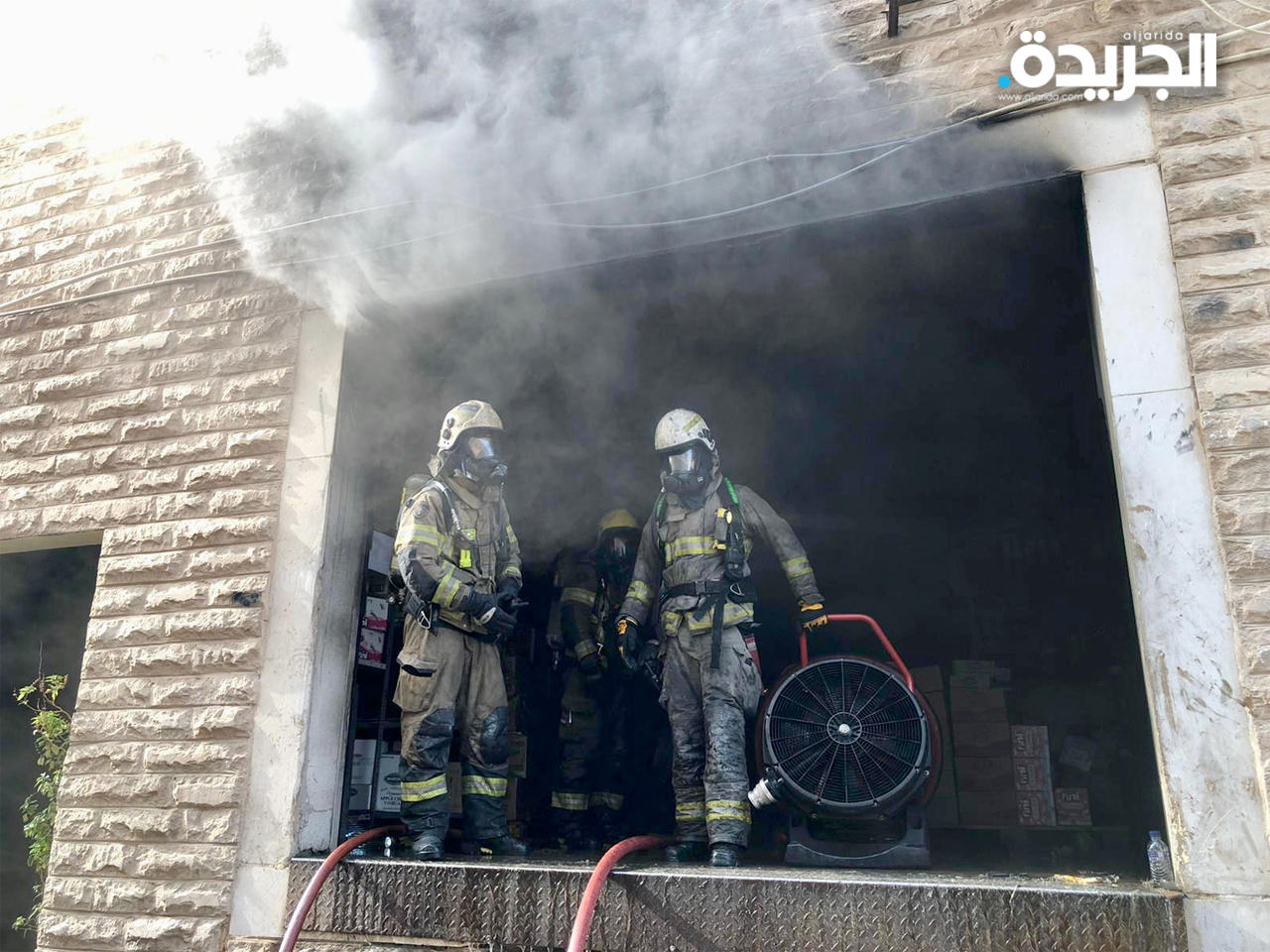 رجلا إطفاء ينفذان عملية تهوية للموقع