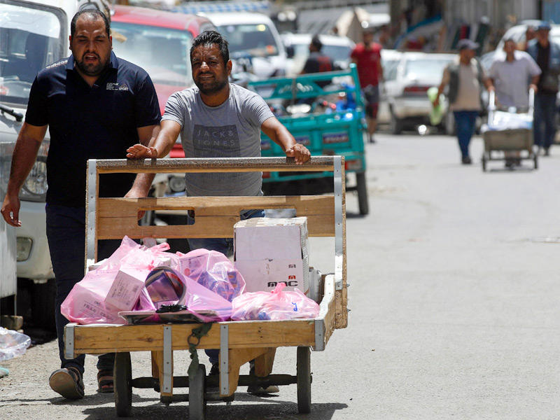حمال عراقي ينقل طلبية في العاصمة بغداد 