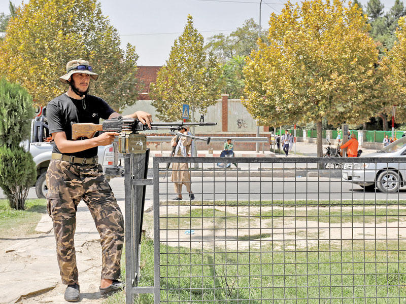 مسلّح من «طالبان» قرب مبنى السفارة الروسية في كابول أمس (رويترز)