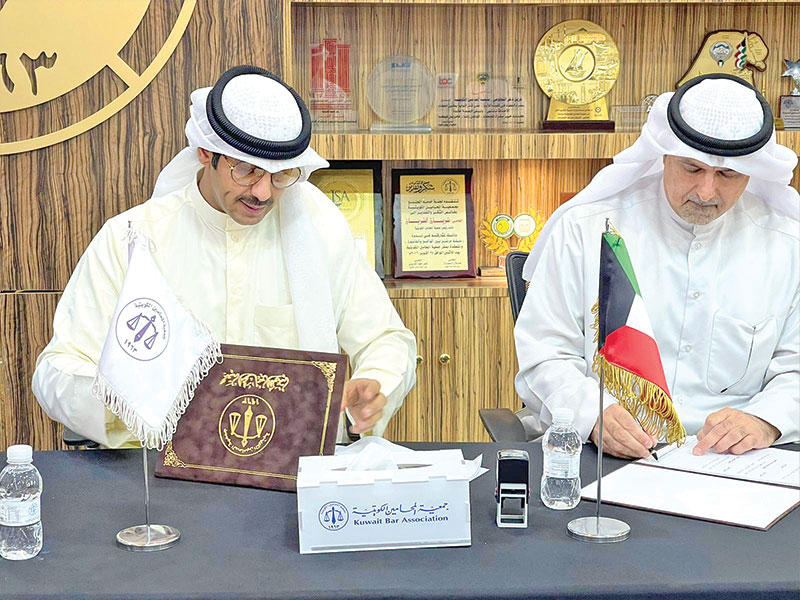 أحمد الكندري عضو مجلس الإدارة لجمعية الكويتية للأسر المتعففة وعبدالرزاق العنزي عضو مجلس الإدارة لجمعية المحامين خلال توقيع المذكرة