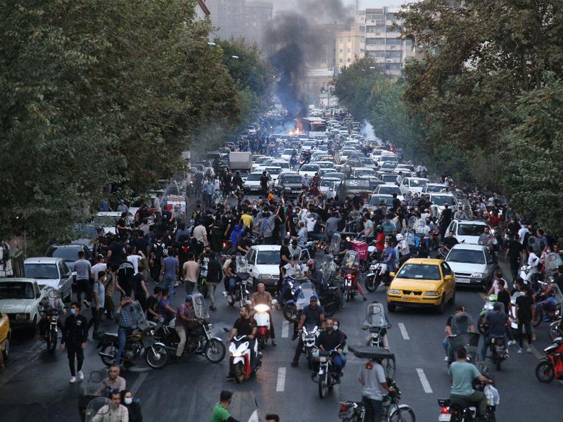 محتجون يقطعون أحد الشوارع الرئيسية في طهران أمس الأول (أ ف ب)